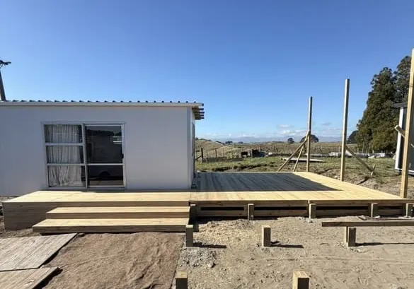 New timber deck under construction beside a sleepout, Palmerston North