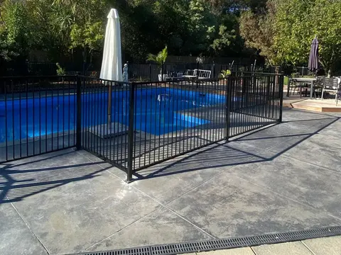 Black aluminium pool fence beside a pool, Palmerston North