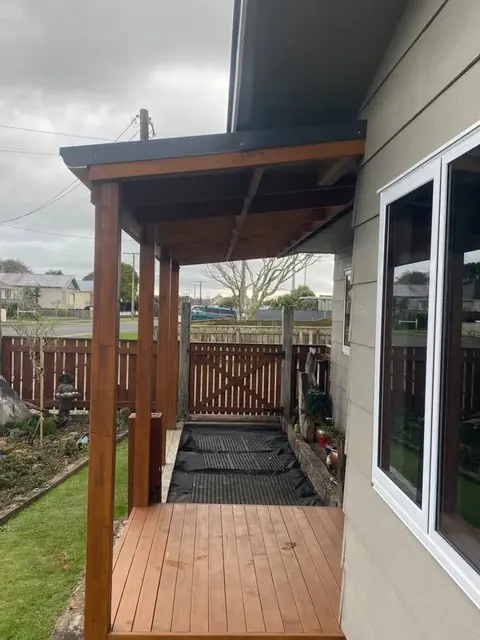 Timber deck with a roof and posts beside the house, Palmerston North