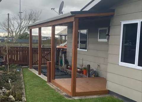 Hardwood deck with a timber-posted roof beside a weatherboard house, Palmerston North
