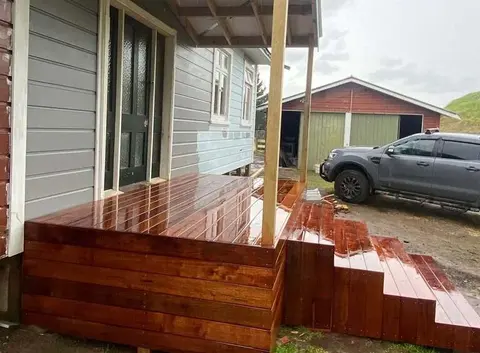 Oiled hardwood deck with wide steps beside a weatherboard house, Palmerston North