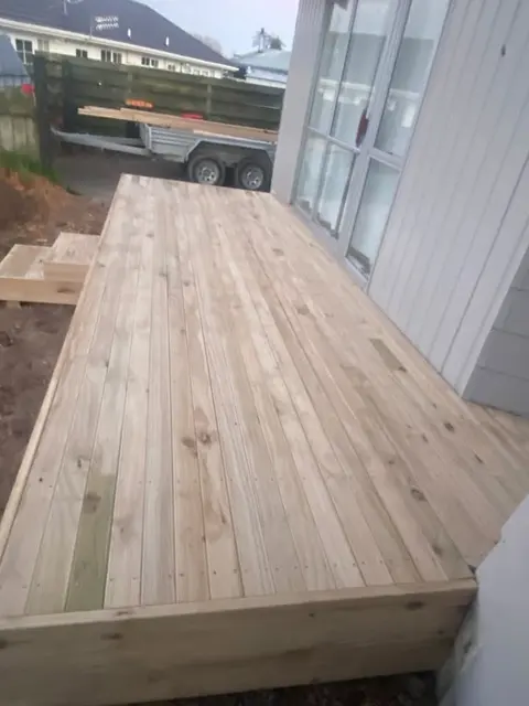 Close-up of new treated pine decking boards against a wall, Palmerston North