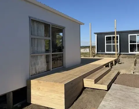 Treated pine deck with wide box steps beside a house, Palmerston North