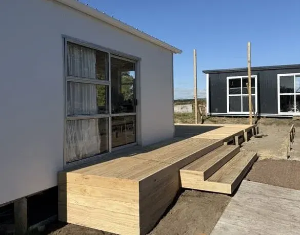 Treated pine deck with wide box steps beside a house, Palmerston North