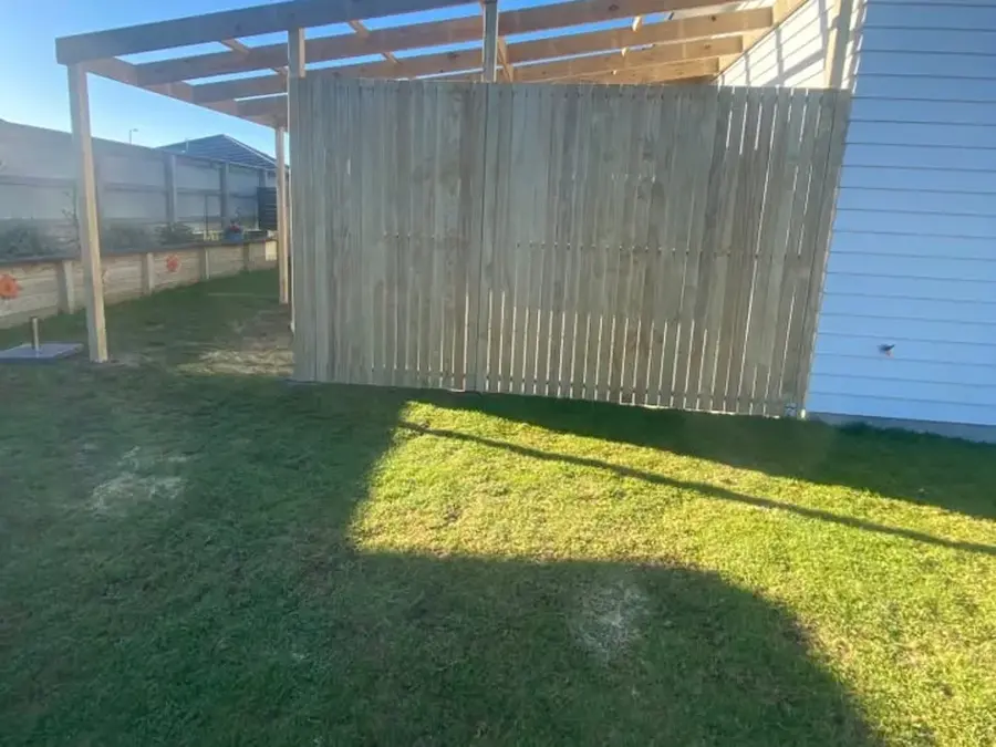 Timber privacy screen beside a pergola frame, Palmerston North