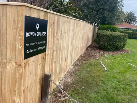 New timber paling fence with a Rowdy Builders sign at a corner, Palmerston North